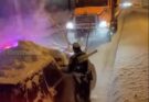 Dashcam footage captures the surreal moment a highway patrol officer is completely engulfed by a wave of snow during a traffic stop